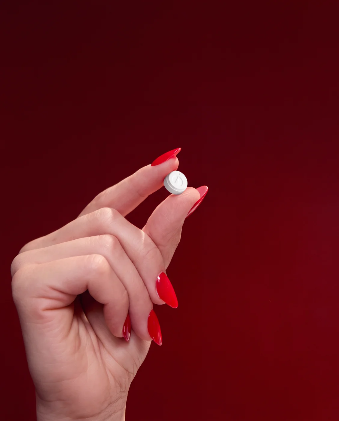 A Rocket Melts tablet held between two fingers