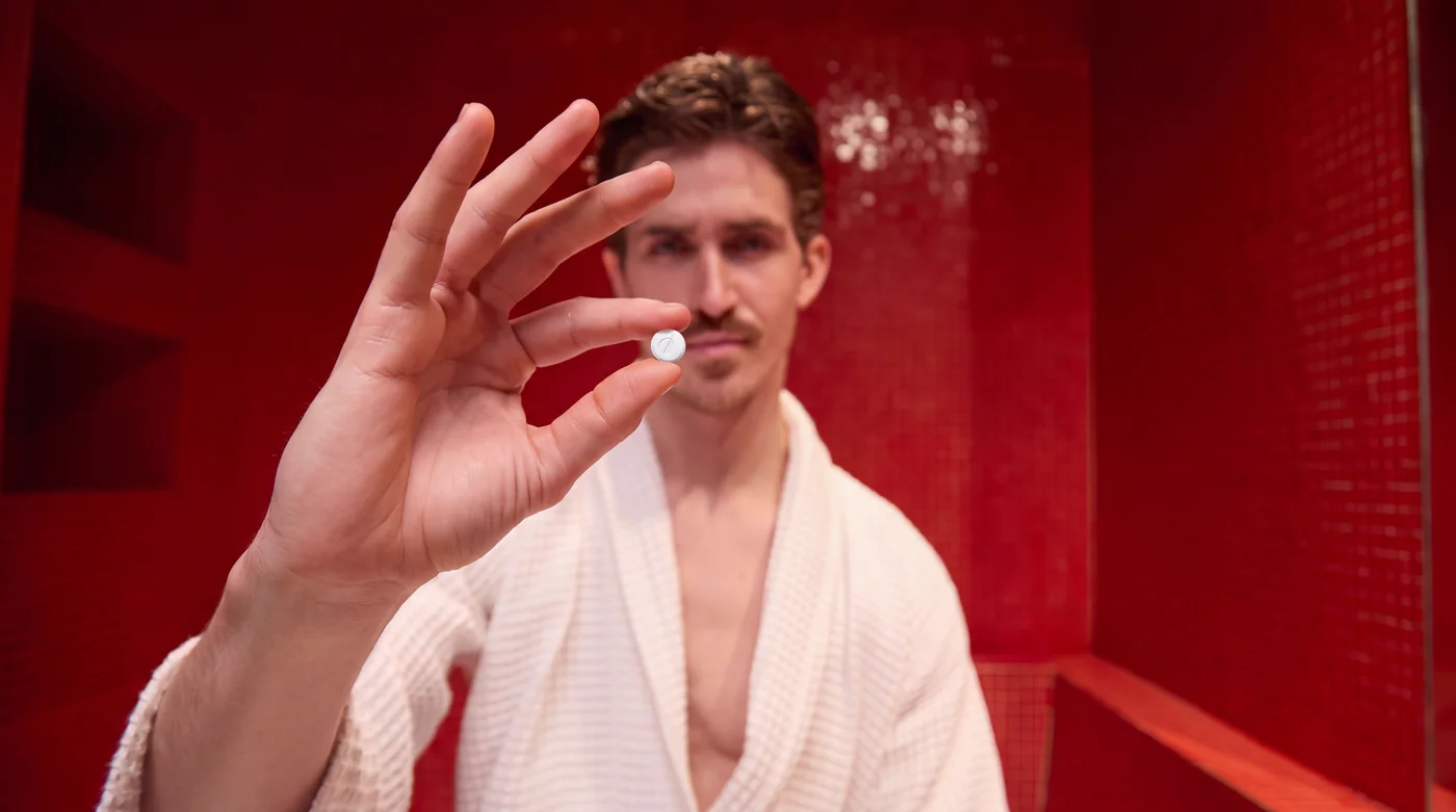 A man holding a small Rocket Melts tablet